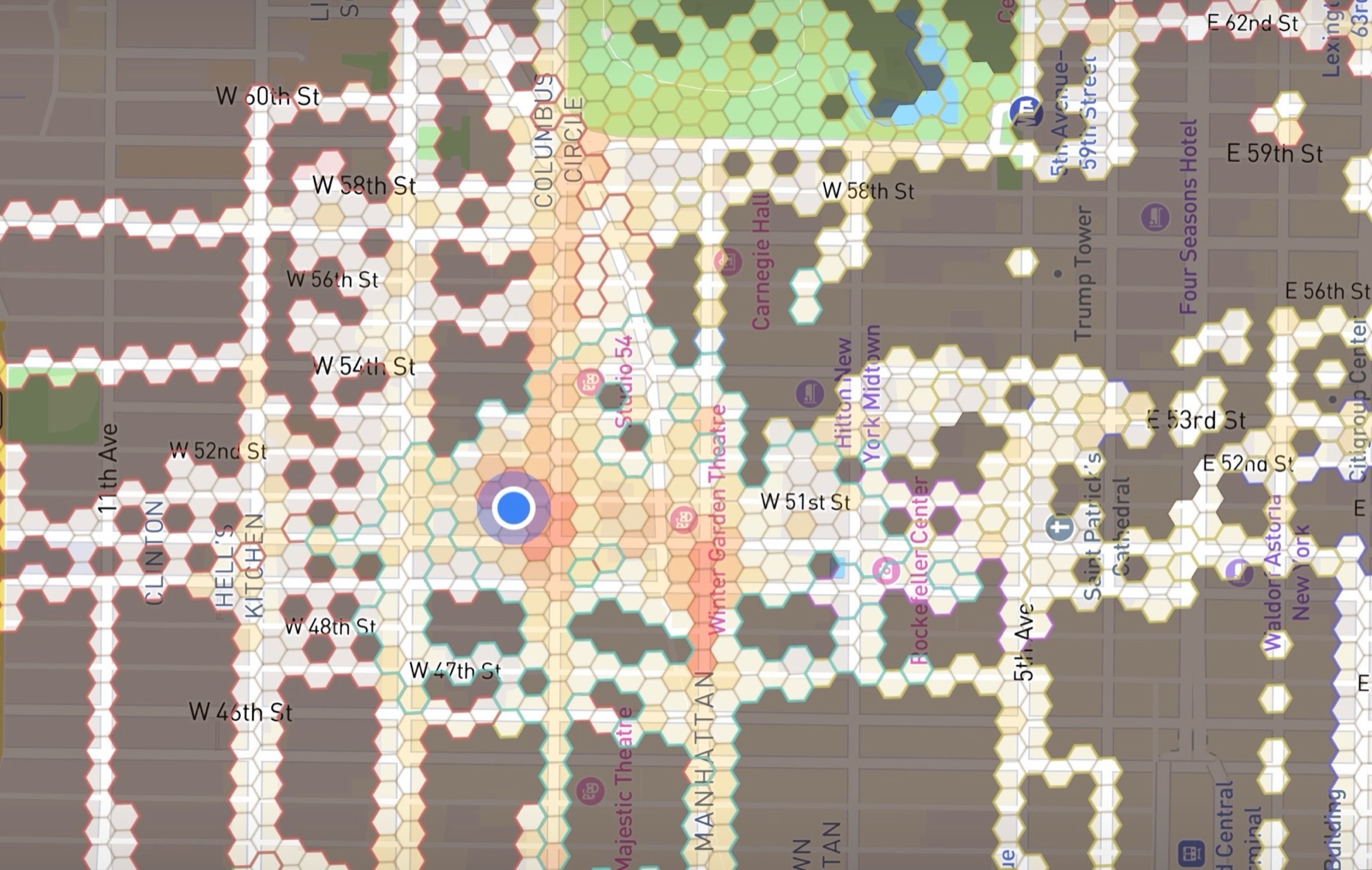 A Manhattan neighborhood revealed hex by hex in Stomped's fog-of-war map, with explored honeycomb tiles around Columbus Circle and Hell's Kitchen