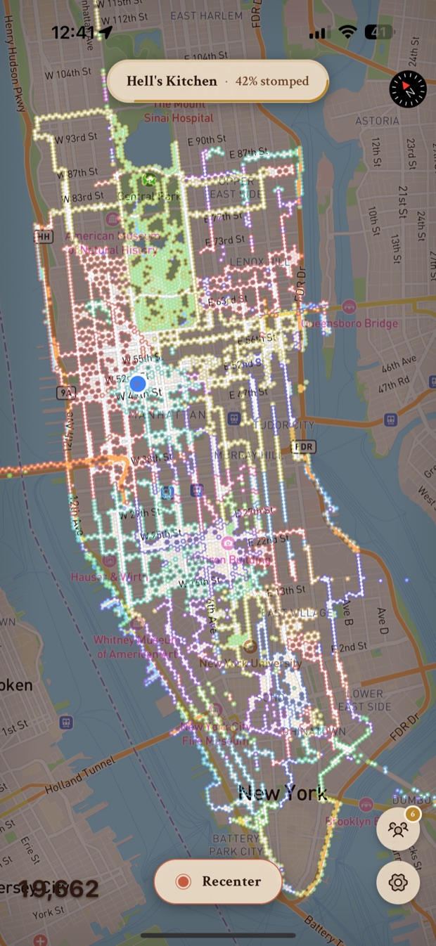 Stomped's fog-of-war map of Manhattan covered in thousands of explored hexagon tiles, with a "Hell's Kitchen · 42% stomped" pill at the top